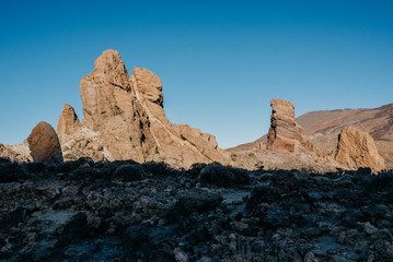 Beautiful rocks with blue sky and a huge shadow on the front in the morning