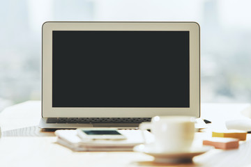 Creative table with blank laptop