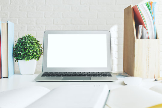 Creative designer desktop with white laptop