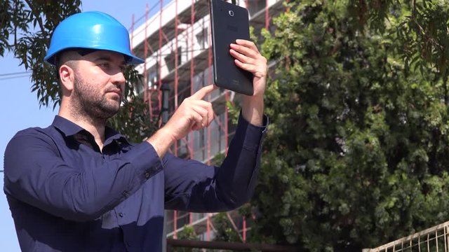 Construction worker workman taking photos to building site supervisor use tablet