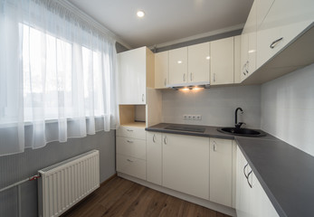 Kitchen in flat. White furniture.