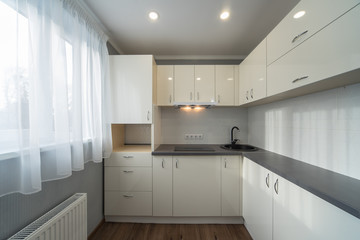 Kitchen in flat. White furniture.