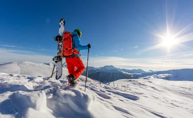 Foto auf Acrylglas Snowboarder walking on snowshoes in powder snow. © Jag_cz