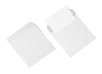White envelope and post card on a background, top view. Blank envelope mockup and blank letterhead presentation template.