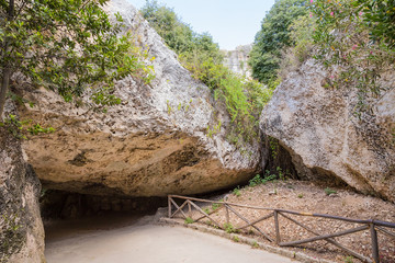 Obraz premium Syracuse, Sicily, Italy. A pedestrian walkway under the rock in the 