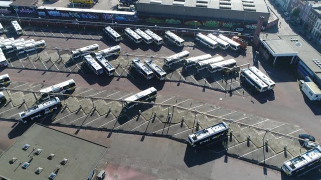 Aerial bird view of bus terminus is designated place where bus or coach starts or ends its scheduled route termini can be located at bus stations interchanges bus garages or bus stops 4k quality