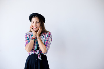  Surprised young woman touching her face and smile