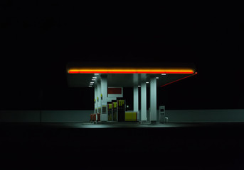Illuminated gas station at night.