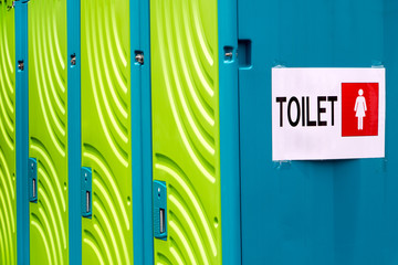 Portable toilets for women. Female toilets. A row of outdoor toilets with gender pictogram.