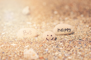 Beautyful sunlight with clean sea sand and the waves are blowing on the beach. Small rocks with inscription, near the water.