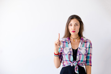 Hipster girl have an idea pointing a finger up