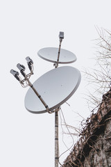 Two round antennas on one rack against sky