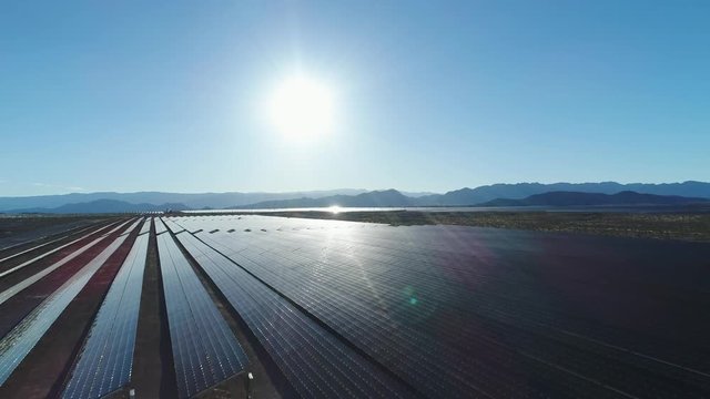 Aerial traveling shot of a large solar farm in a desert