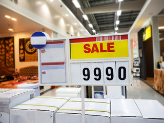real red sale text on yellow background with price standy in superstore  