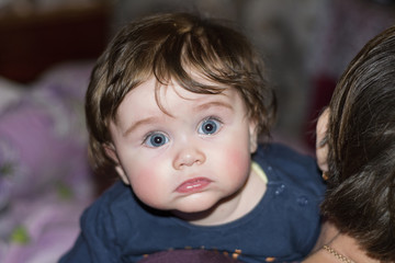 A beautiful little granddaughter hugs her grandmother firmly