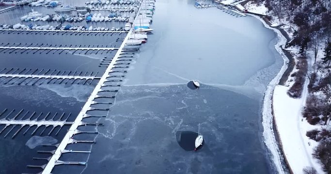 Aerial footage of frozen Frognerkilen Marina in Oslo, Norway in winter 2018