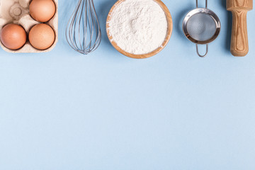 Ingredients for baking  on a blue background.