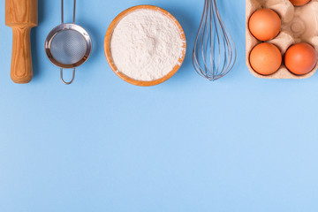 Ingredients for baking  on a blue background.