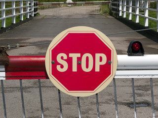 Stop sign on a barrier of a swing bridge over the Gloucester and Sharpness Canal, UK