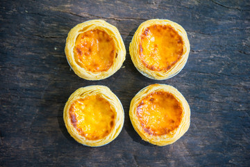 Freshly baked delicious egg tart on wooden