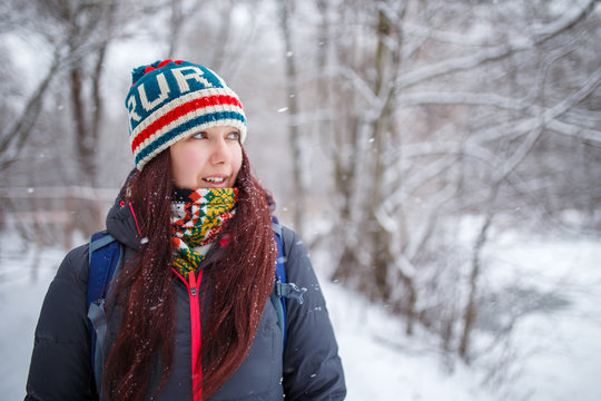 Portrait of woman with long hair in winter forest