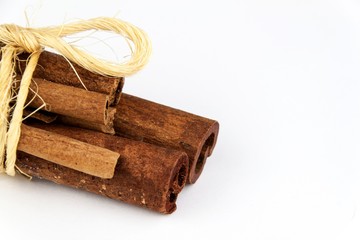 Cinnamon pieces on a white background. Sales of aromatic spices.