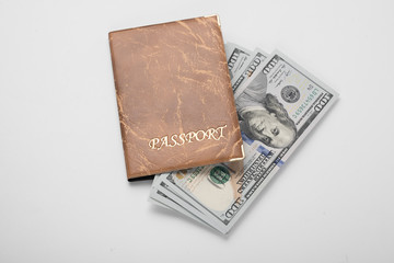 Dollars in an orange passport on a white background, overall