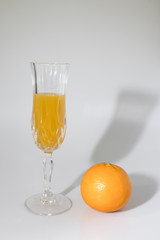 Orange juice with orange in a white background composition