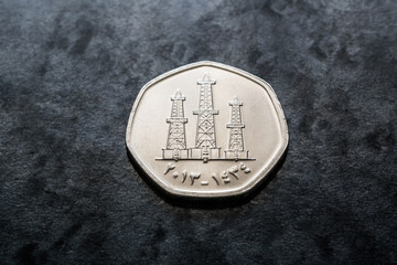 United Arab Emirates currency, Fifty fils coin with oil derricks reverse on black gray background close up