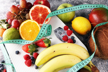 Healthy living or Diet concept. Fruits with measuring tape and a weight scale