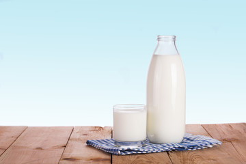  Milk bottle and glass on a blue background