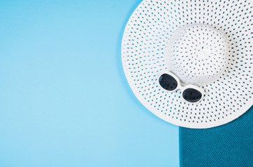 Top view sandy beach concept. Graphical paper background with copy space around products. Punchy pastel colours and frame composition. Hipster or millenial traveler theme.