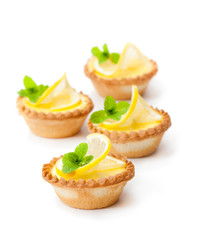 egg  custard tarts with lemon isolated on white