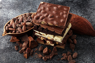 Chocolate bars on dark background with chocolate tower