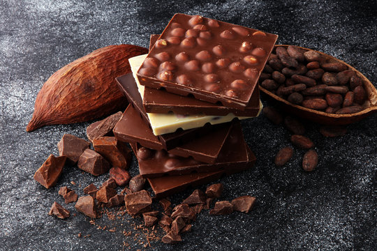 Chocolate bars on dark background with chocolate tower