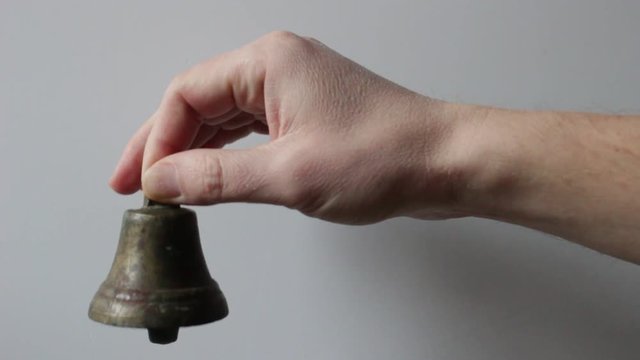 The bell in hand on white background