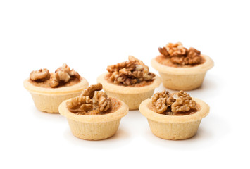 mini  ginger and walnut tarts isolated on white