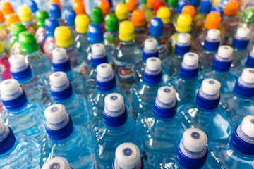 Plastic bottles, colorful caps. Plastic bottles with water, lids.