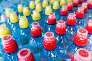 Plastic bottles, colorful caps. Plastic bottles with water, lids.