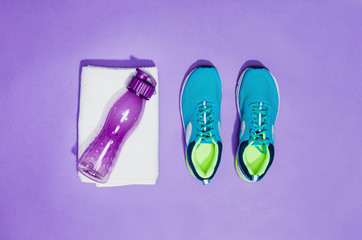 Fitness accessories, healthy and active lifestyles concept background with copy space for text. Products with vibrant, punchy pastel colours and frame composition. Image taken from above, top view.