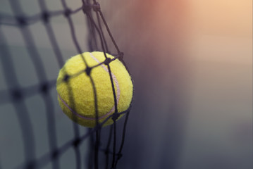 Tennis ball hitting the tennis net at tennis court with copy space. - obrazy, fototapety, plakaty