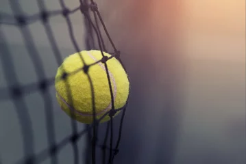 Zelfklevend Fotobehang Tennis ball hitting the tennis net at tennis court with copy space. © yuthana Choradet