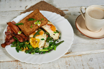 Traditional Breakfast, eggs with bacon and herbs