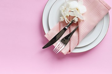 Obraz premium Festive table setting for Valentines Day, Easter, Mother's Day ore wedding. Elegant table decoration with fresh orchid. Overhead view with copy spase