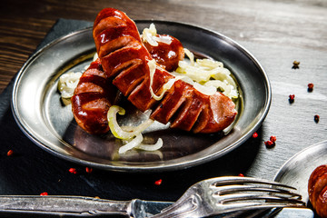 Grilled sausages on wooden table