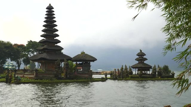 ulun danu beratan temple framed by bamboo on bali, indonesia