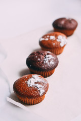 Homemade delicious chocolate muffins close-up, vertical
