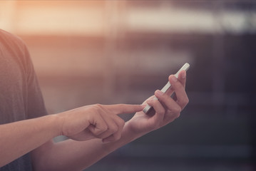 Closeup of man's hand using smartphone with copy space.