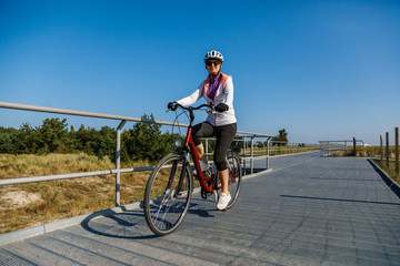 Healthy lifestyle - middle-aged woman riding bicycles