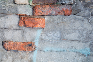 grunge plaster texture with red bricks